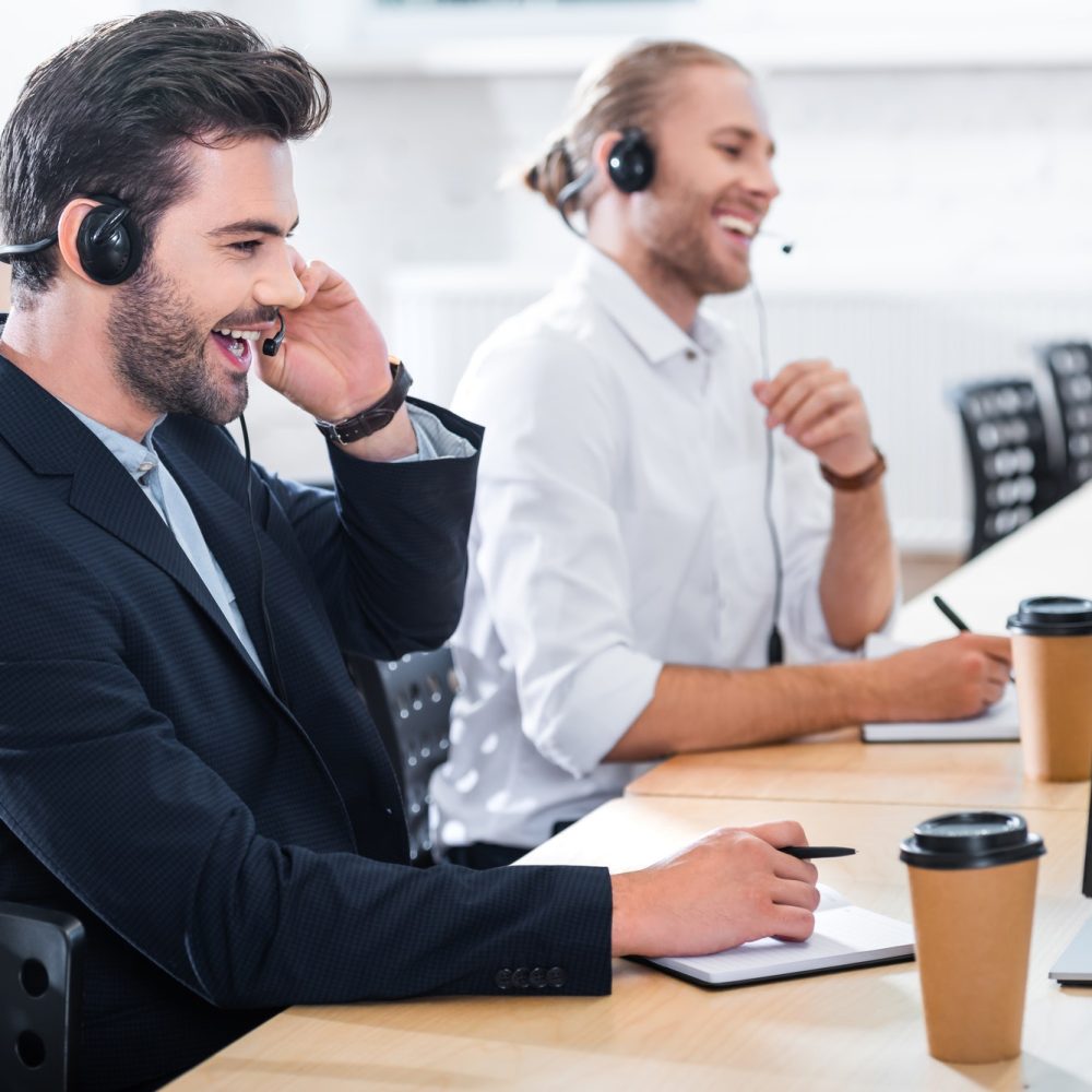 side-view-of-male-call-center-operators-in-headsets-at-workplace-in-office.jpg side-view-of-male-call-center-operators-in-headsets-at-workplace-in-office.jpg