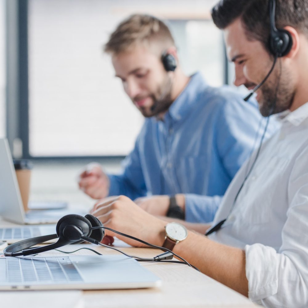 smiling-young-call-center-operators-in-headsets-using-laptops-in-office.jpg smiling-young-call-center-operators-in-headsets-using-laptops-in-office.jpg